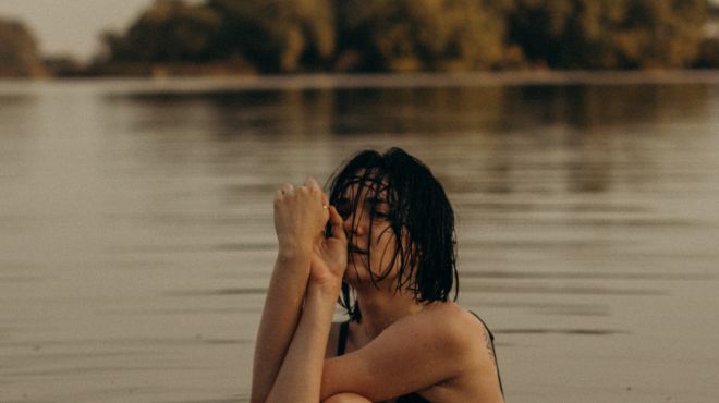 Girl thinking something in dream of swimming in a lake
