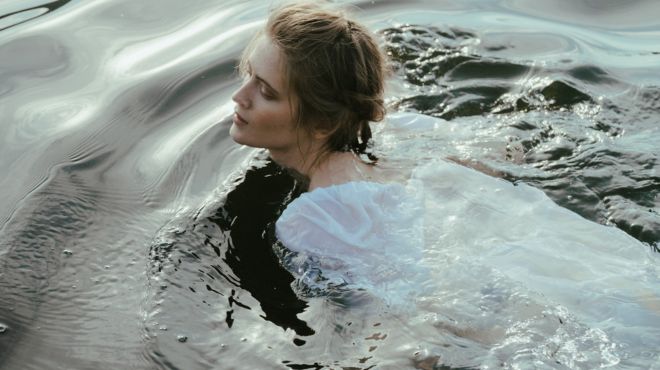 girl in water with a white dress