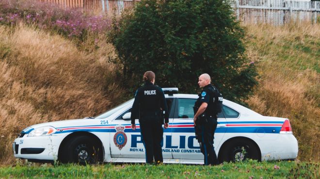 two police offficers standing outside a house
