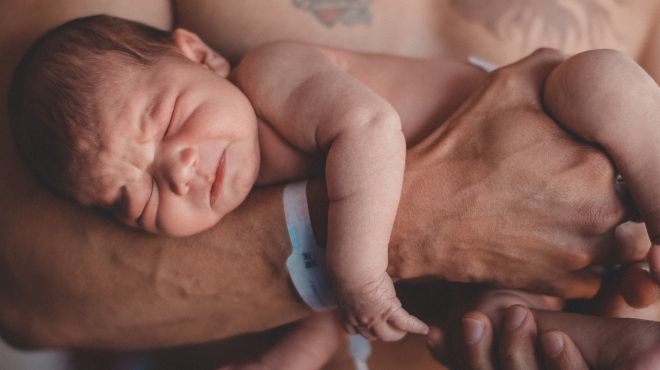 man holding a newborn baby in a dream