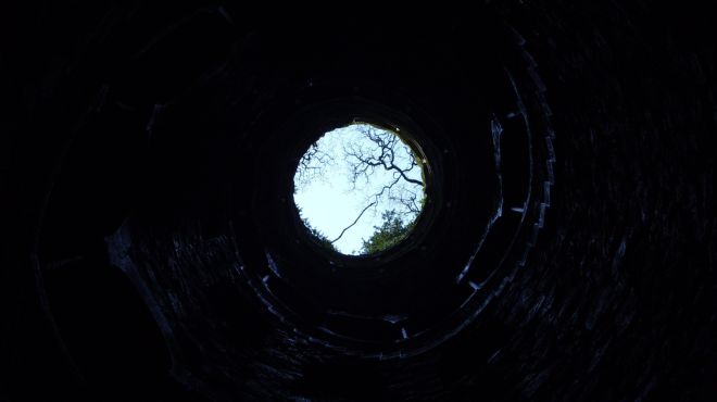 man dream of climbing out of a dark hole