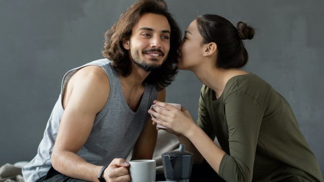 women mimic a secret to another mans ears