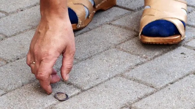 man dreaming about finding coins on the ground while he is on a walk