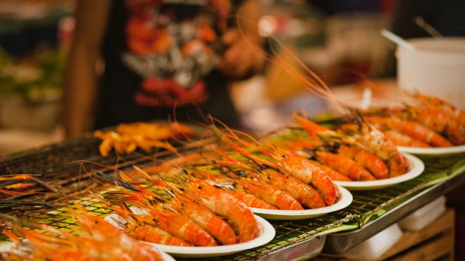 man dreaming about tasty shrimp seafood stall