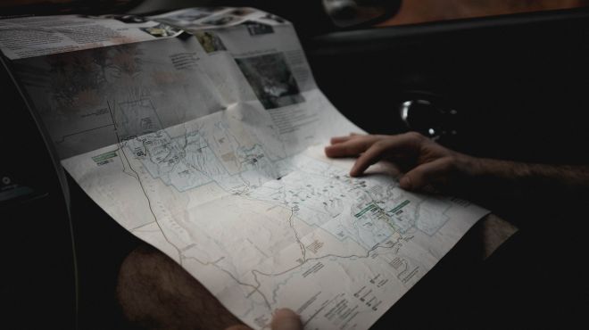 man looking at a map to figure out the way forward