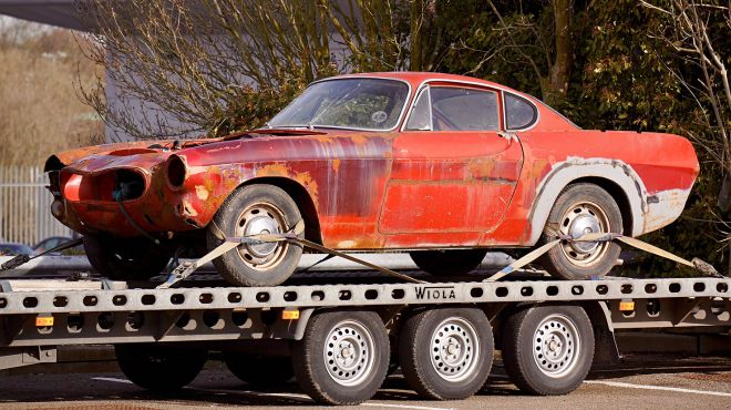 old red car towed for restoration