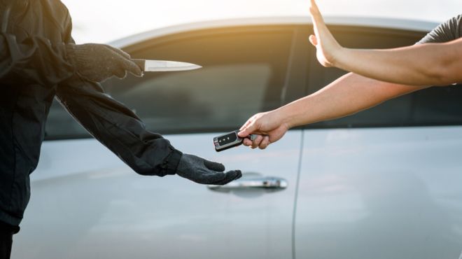 man dreaming of being robbed his car key with a knifepoint